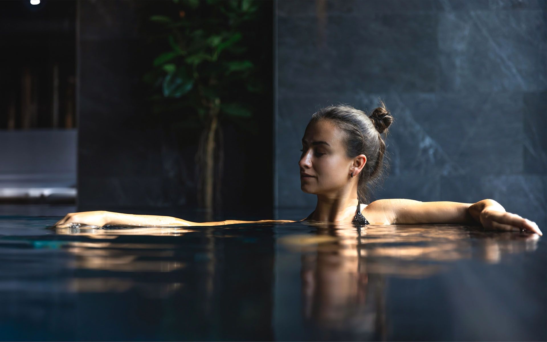 Frau entspannt im Spa-Pool im Wellnessbereich