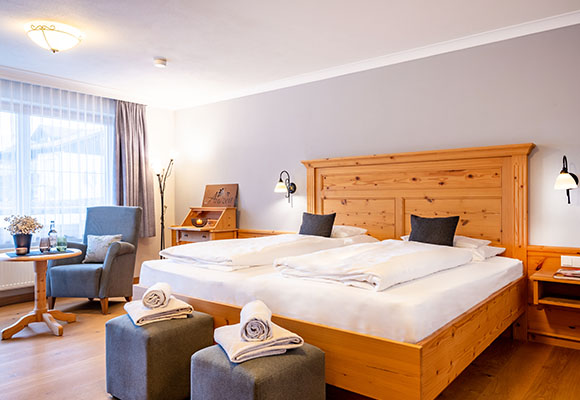 Familienzimmer mit Doppelbett, Sitzmöbeln und Balkonblick