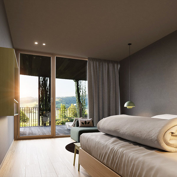 Einzelzimmer mit Bett und Blick auf Balkon