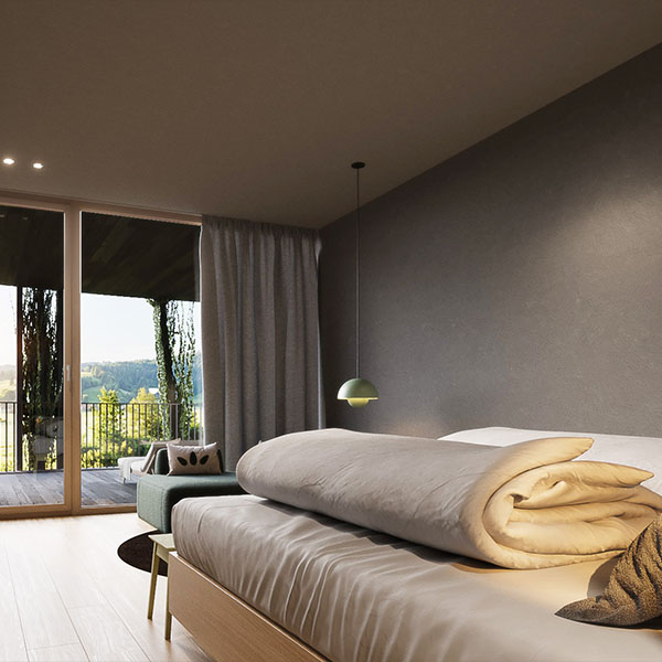 Einzelzimmer mit Bett und gemütlicher Sitzecke