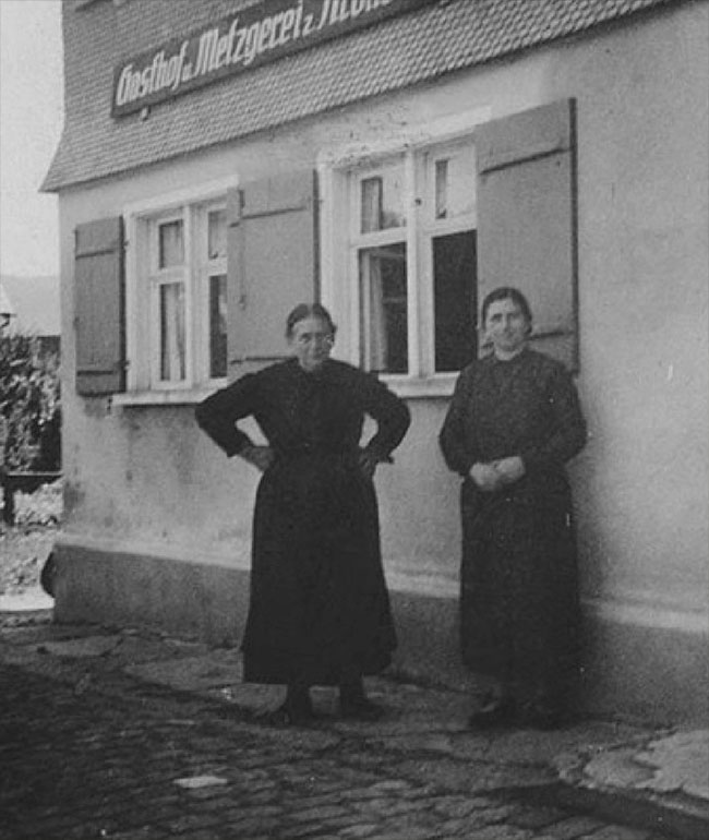 Historisches Schwarz-Weiß-Foto mit zwei Frauen vor dem Gasthaus Fanny